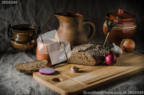 Image of Still life with homemade bread and pottery