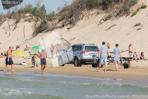 Image of Anapa, Russia - September 20, 2015: Jeep with insolent driver rides on the beach with holidaymakers