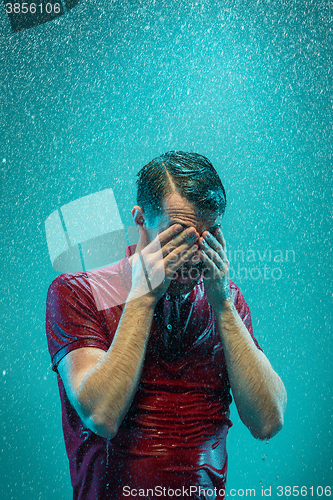 Image of The portrait of young man in the rain