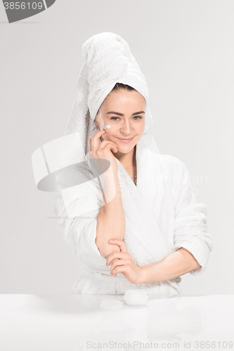 Image of Cute nice girl with cream in her face