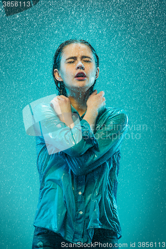 Image of The portrait of young beautiful woman in the rain