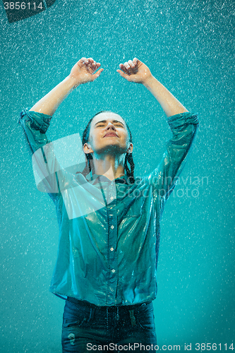 Image of The portrait of young beautiful woman in the rain