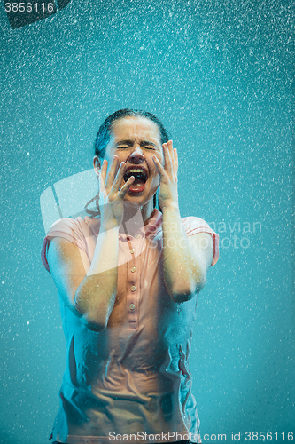 Image of The portrait of young beautiful woman in the rain