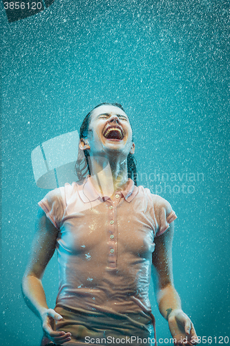 Image of The portrait of young beautiful woman in the rain