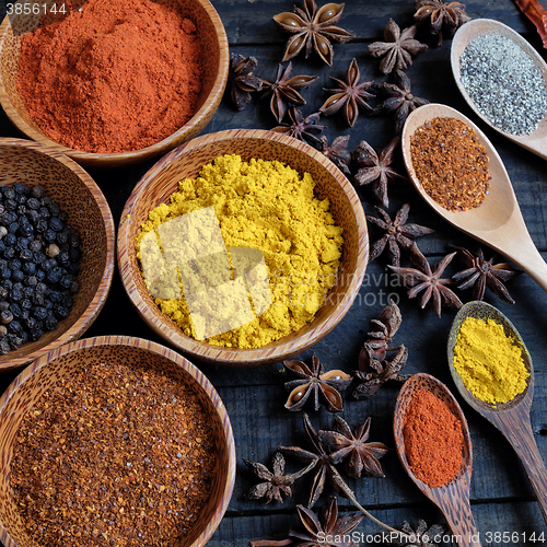 Image of Colorful spice powder, chilli, pepper, turmeric, cashew 