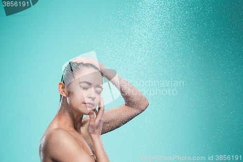 Image of Woman enjoying water in the shower under a jet