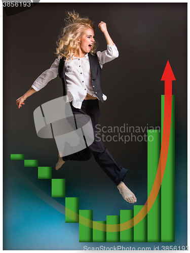 Image of Businesswoman runing up a stairway and growing sales chart