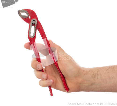 Image of Hand of male plumber with a red wrench