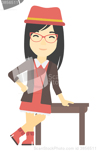 Image of Woman leaning on table.