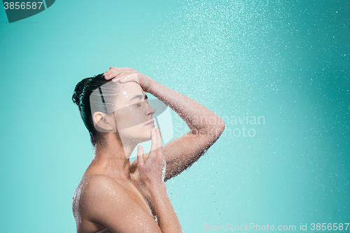 Image of Woman enjoying water in the shower under a jet