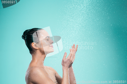 Image of Woman enjoying water in the shower under a jet