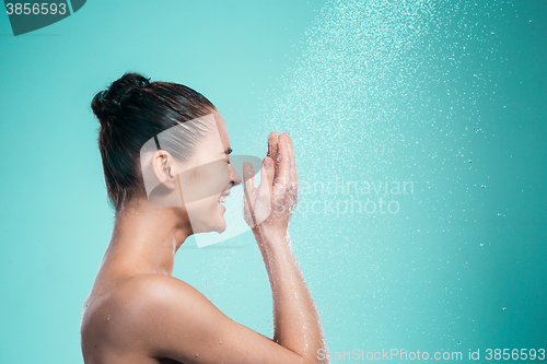 Image of Woman enjoying water in the shower under a jet