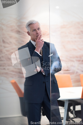 Image of portrait of handsome senior business man at modern office