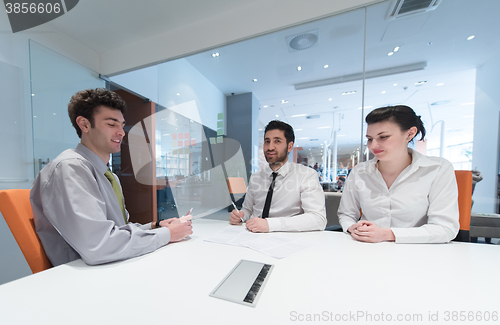 Image of young couple signing contract documents on partners back