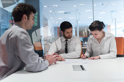 Image of young couple signing contract documents on partners back