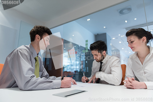 Image of young couple signing contract documents on partners back