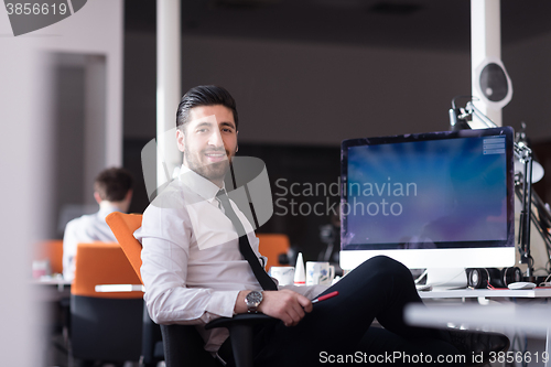 Image of young business man  working on desktop computer