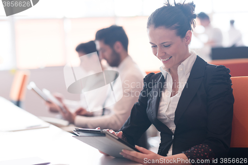 Image of business woman on meeting  using tablet