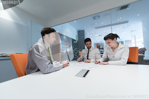 Image of young couple signing contract documents on partners back