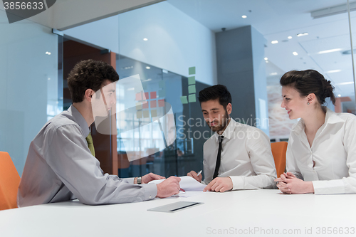 Image of young couple signing contract documents on partners back