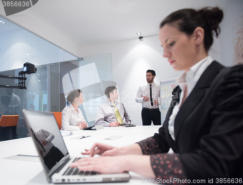 Image of young business woman on meeting  using laptop computer