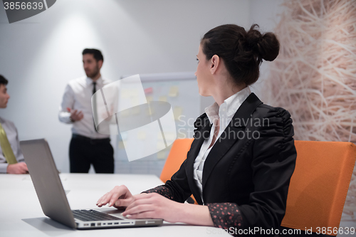 Image of young business woman on meeting  using laptop computer