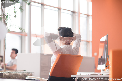 Image of happy young business woman relaxing and geting insiration