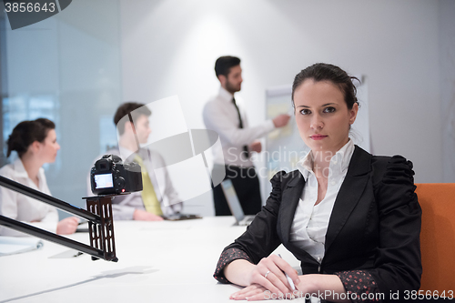 Image of young business woman on meeting  using laptop computer