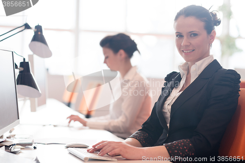 Image of business woman at  office people group in background