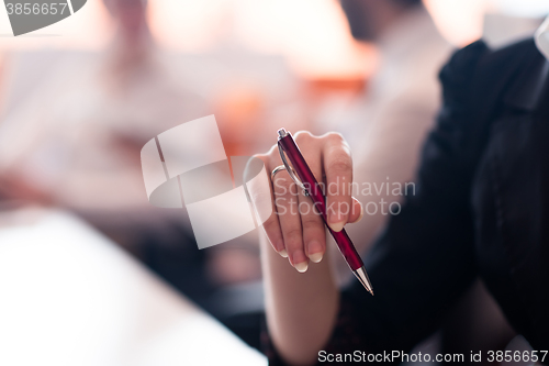 Image of woman hands holding pen on business meeting