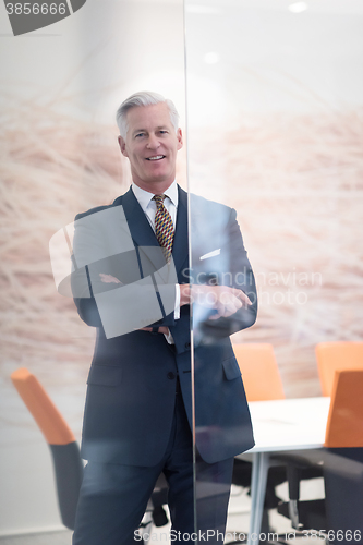 Image of portrait of handsome senior business man at modern office