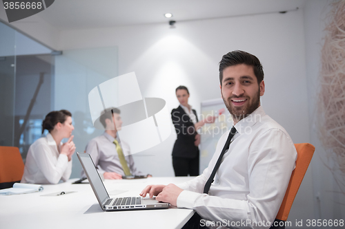 Image of young business man at meeting