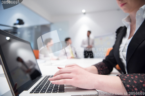 Image of woman hands typing on laptop keyboard at business meeting