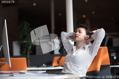 Image of happy young business woman relaxing and geting insiration