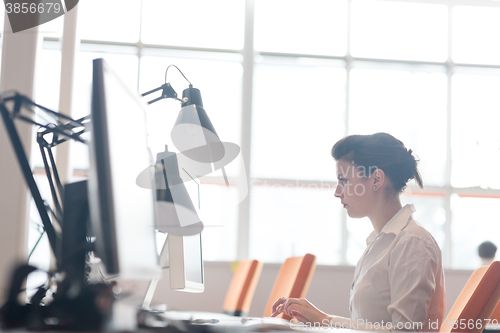 Image of business woman working on computer at office