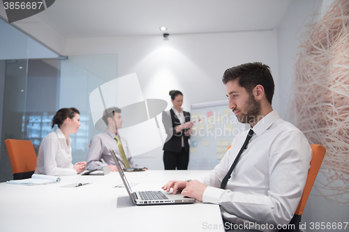 Image of young business man at meeting