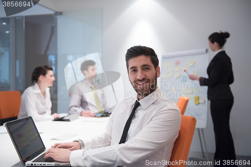 Image of young business man at meeting