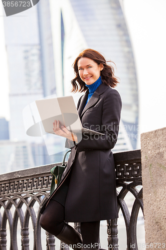 Image of beautiful woman with a laptop