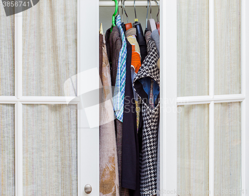 Image of clothes in a white wardrobe
