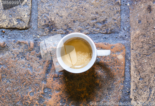 Image of cup of coffee on a rustic floor