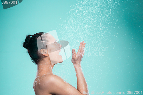 Image of Woman enjoying water in the shower under a jet