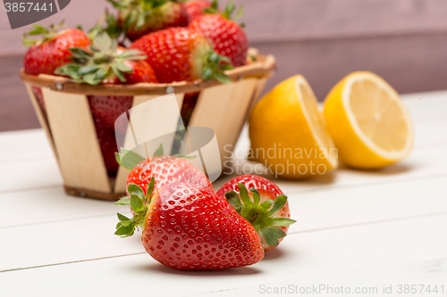 Image of Strawberries in a small basket and lemon