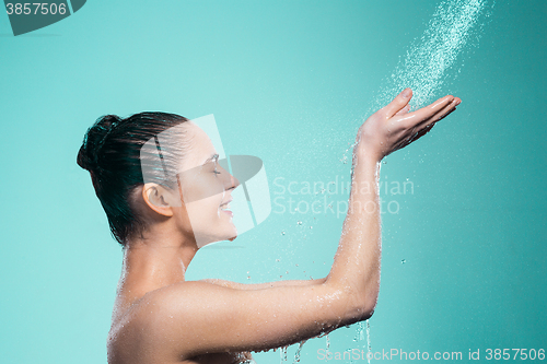 Image of Woman enjoying water in the shower under a jet