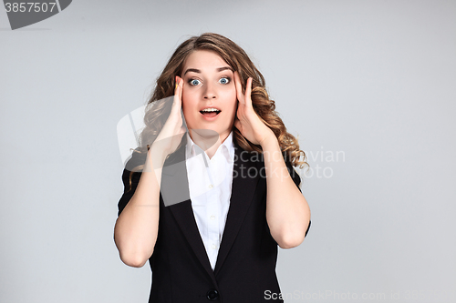 Image of Portrait of young woman with shocked facial expression