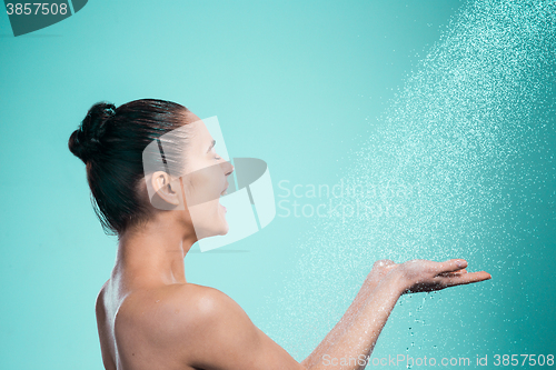 Image of Woman enjoying water in the shower under a jet