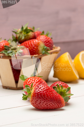 Image of Strawberries in a small basket and lemon