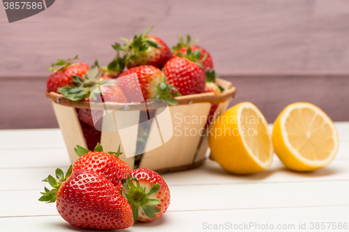 Image of Strawberries in a small basket and lemon