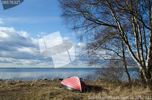 Image of Small rowing boat up side down by the coast