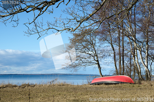 Image of Coastal spring season view with a small rowing boat on land