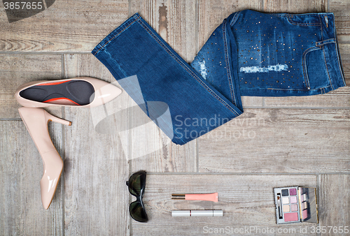 Image of Flat lay picture of girl\'s jeans and accessories